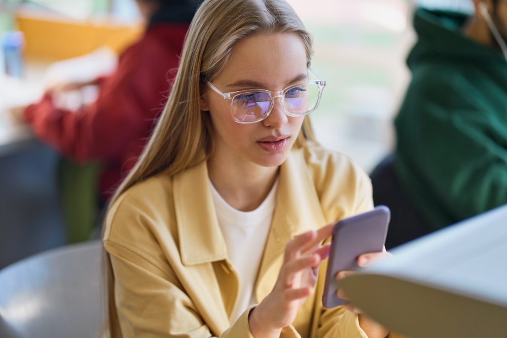 Teen,Girl,Gen,Z,Student,Using,Mobile,Phone,Looking,At
